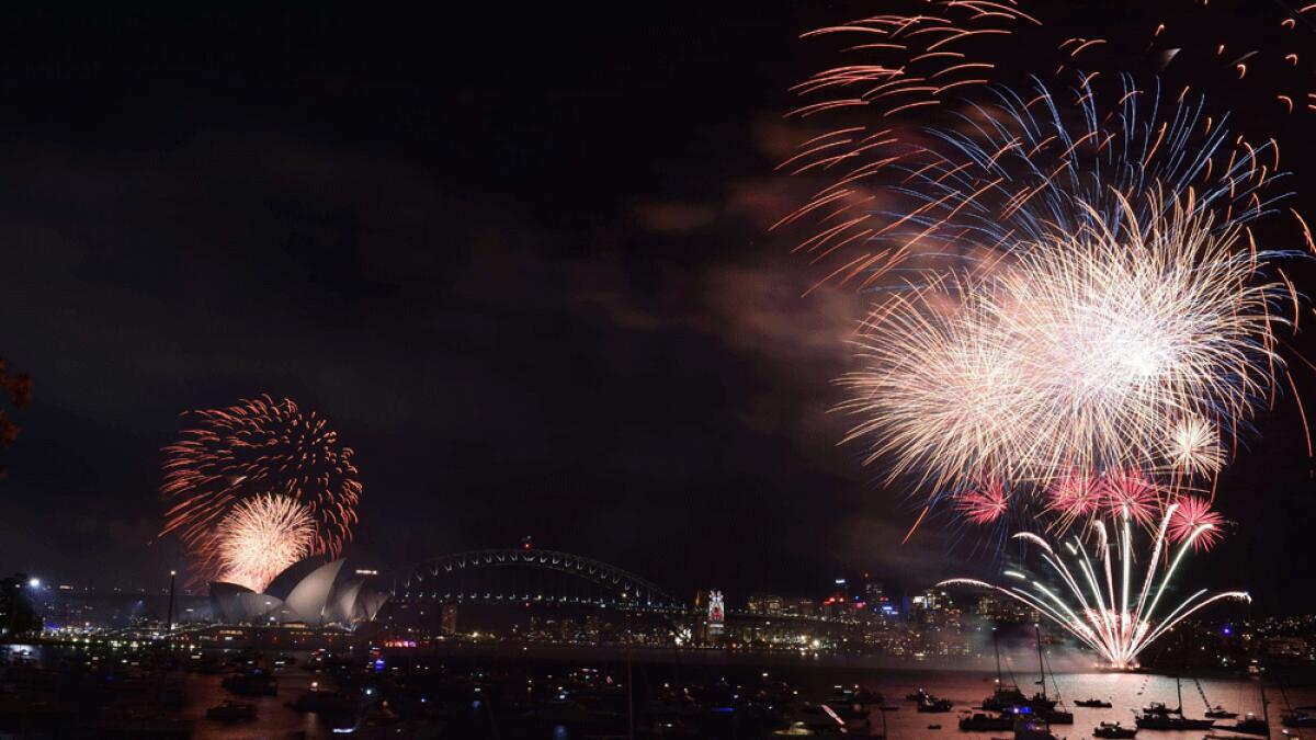 New Year's Eve fireworks illuminate Sydney's iconic Harbour Bridge and Opera House during the traditional early family fireworks show held before the main midnight event.