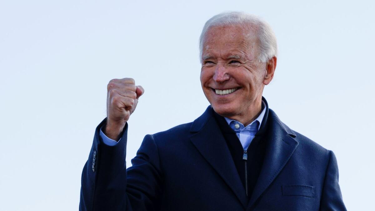 Democratic U.S. presidential nominee and former Vice President Joe Biden makes a fist during a drive-in campaign stop, in Des Moines, Iowa, U.S., October 30, 2020.