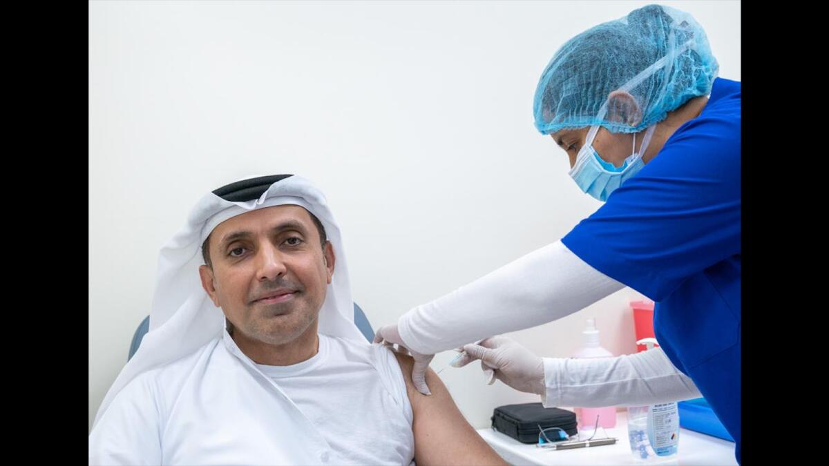 Major-General Talal Hamid Belhoul Al Falasi, Director-General of State Security Department in Dubai, receives his first shot of the Pfizer-BioNTech Covid-19 vaccine.