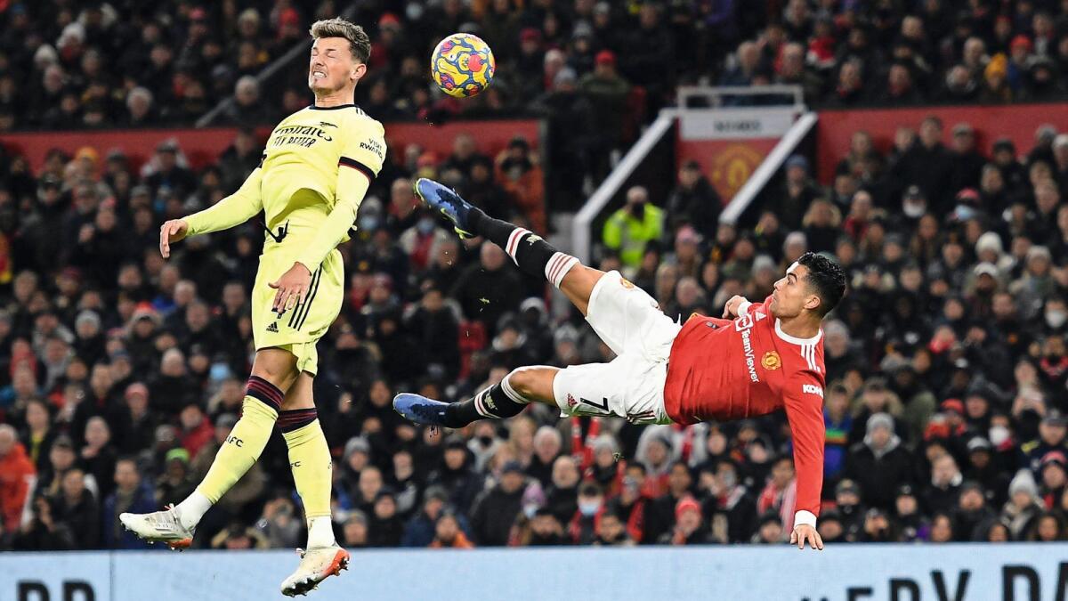 Manchester United’s Cristiano Ronaldo (right) attempts an overhead kick past Arsenal’s Ben White at Old Trafford on Thursday. — AFP