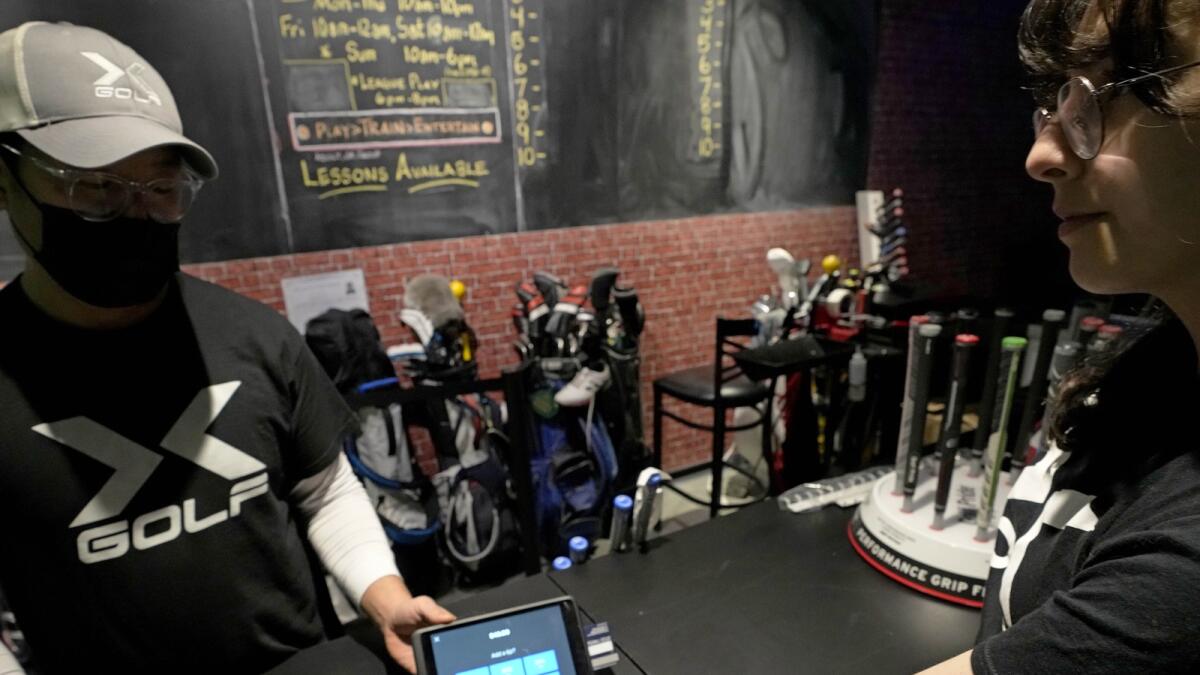 A tipping option is displayed on a card reader tablet at X-Golf indoor golf in Glenview, Ill., on Jan. 10, 2023. — AP