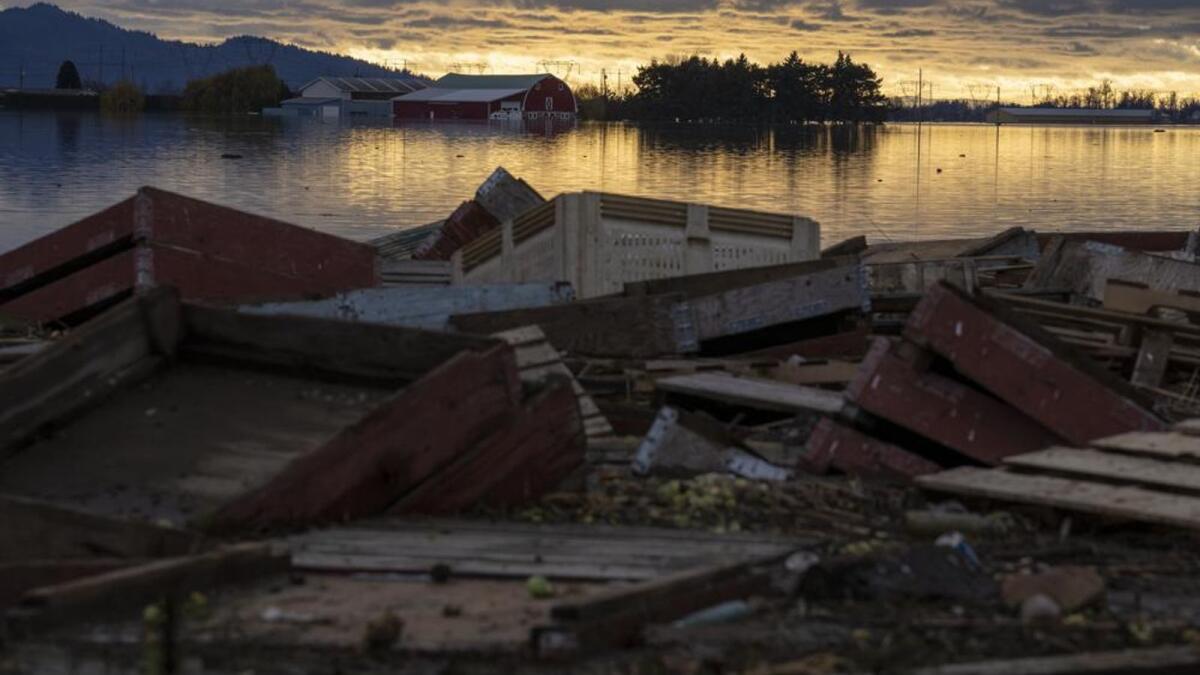 Debris is piled up as farms are surrounded by floodwaters caused by heavy rains and mudslides in Abbotsford, British Columbia. (Photo: AP)