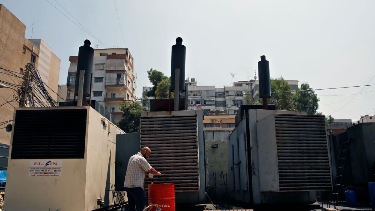 A man refuels privately-owned diesel generators that provide power to homes and businesses, in Beirut, Lebanon. — AP file