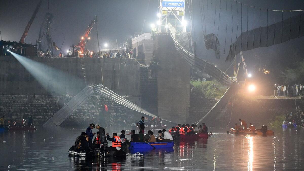 Indian rescue personnel conduct search operations after a bridge across the river Machchhu collapsed in Morbi, some 220km from Ahmedabad, early on Monday. — AFP