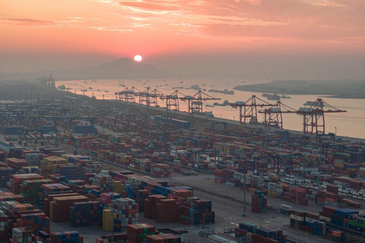 Shipping containers stacked at Nanjing port in China's eastern Jiangsu province. The World Bank projected global growth to slow for the third year in a row. — AFP