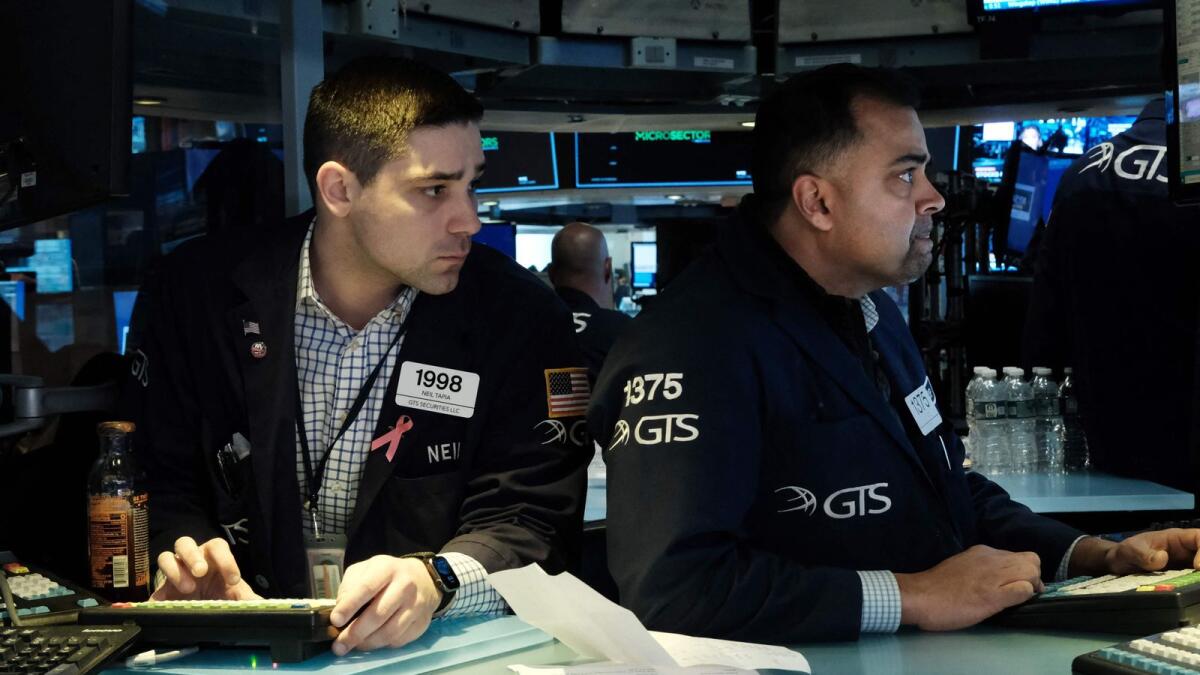 Traders at the New York Stock Exchange on Friday. - AFP