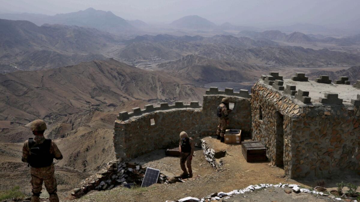 Pakistan Army troops observe the area from hilltop post in Khyber district. — AP file