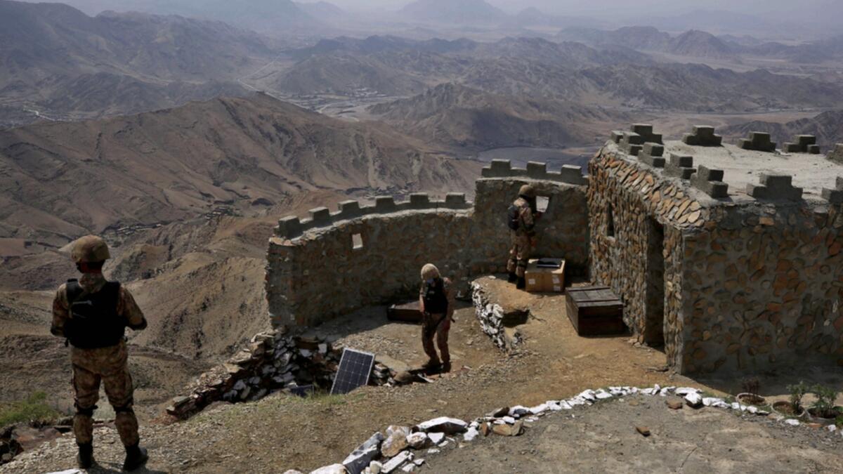 Pakistan Army troops observe the area from hilltop post in Khyber district. — AP file
