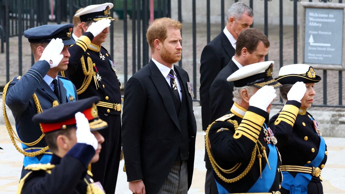Britain's Prince Harry, Duke of Sussex, stands next to King Charles, Anne, Princess Royal, and William, Prince of Wales, as they salute outside the abbey.