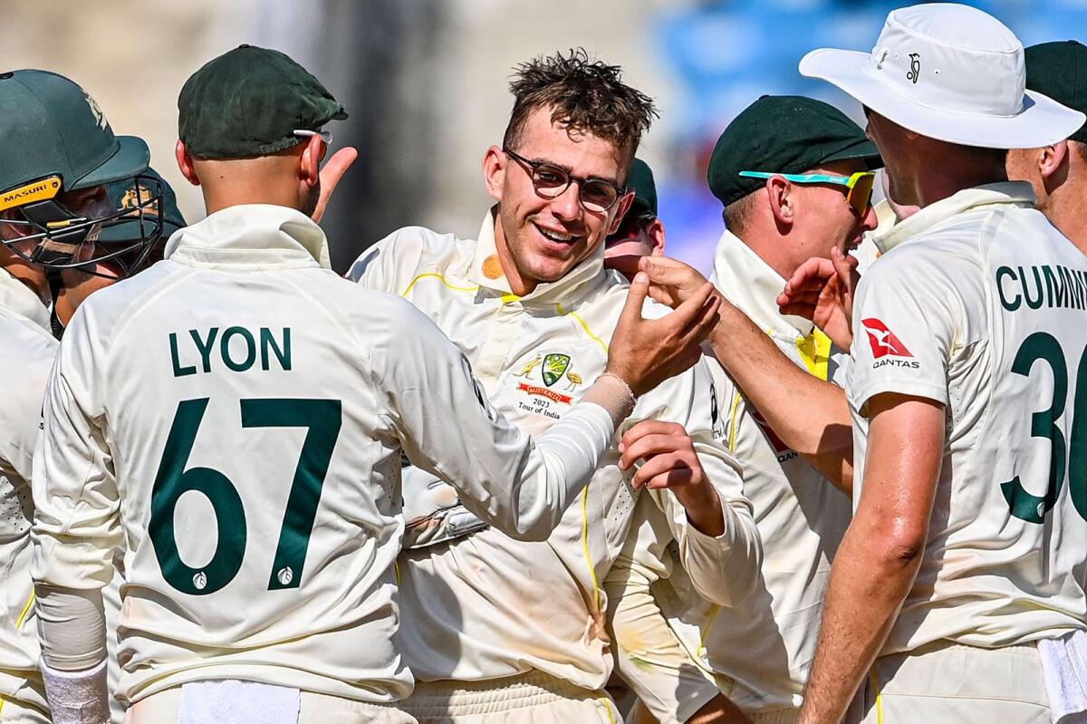 Australian players celebrates with teammate Todd Murphy (centre) after his fifth wicket. — AFP