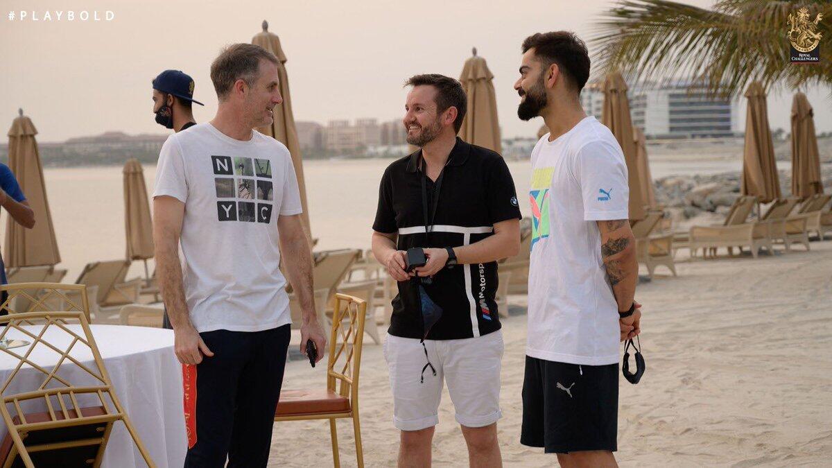 Virat Kohli, head coach Simon Katich and director of cricket Mike Hesson interact with each other