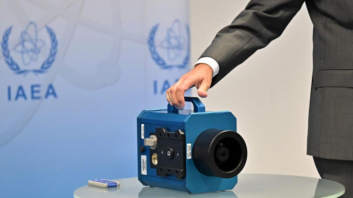 Rafael Grossi, Director General of the International Atomic Energy Agency (IAEA), displays a camera used in Iran during a press conference at the agency's headquarters in Vienna, Austria. AFP