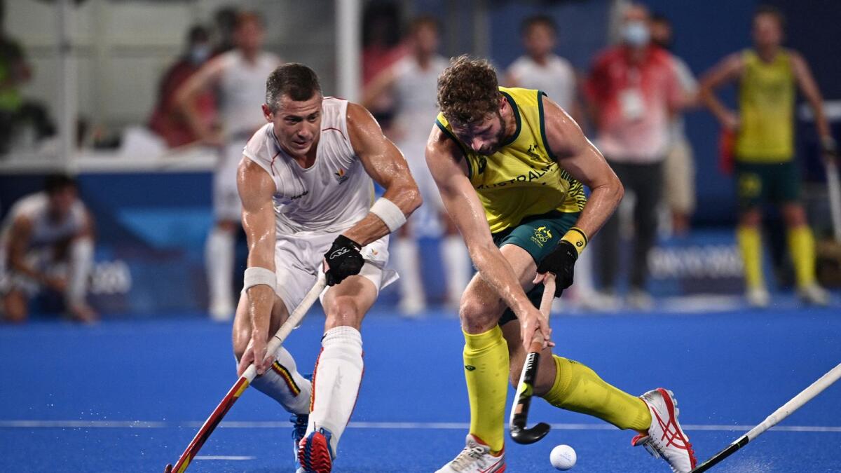 Australia's Joshua Beltz (right) is challenged by Belgium's John-John Dominique Dohmen during the men's gold medal match of the Tokyo 2020 Olympic Games field hockey competition. — AFP