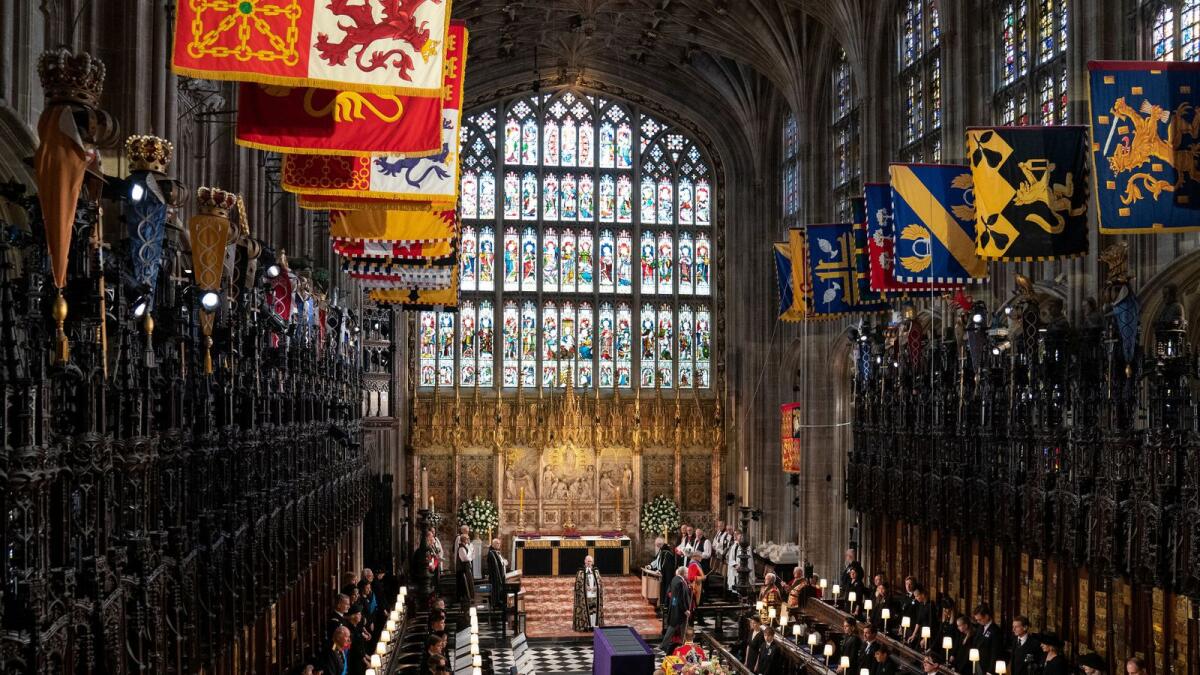 Queen Elizabeth II's coffin is draped in the Royal Standard with the Imperial State Crown, and the Sovereign's orb and sceptre, during the Committal Service at St George's Chapel in Windsor Castle, Berkshire.