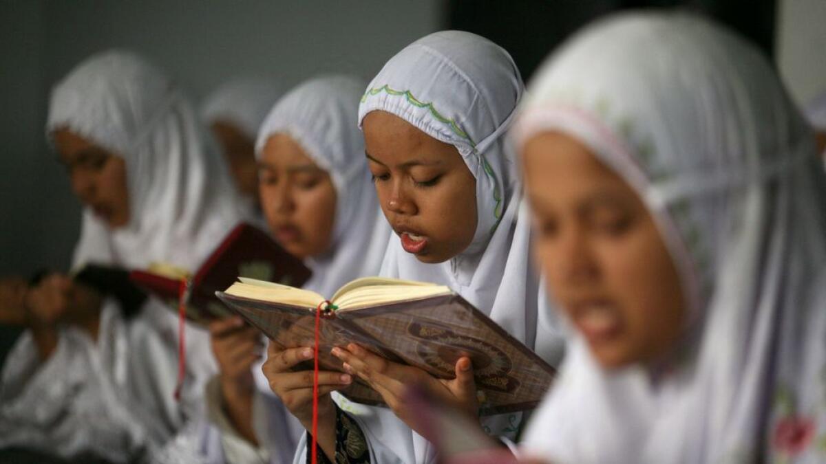 Students read Quran on the first day of the holy fasting month of Ramadan at Ar-Raudlatul Hasanah Islamic boarding school in Medan, North Sumatra, Indonesia, Monday, June 6, 2016.