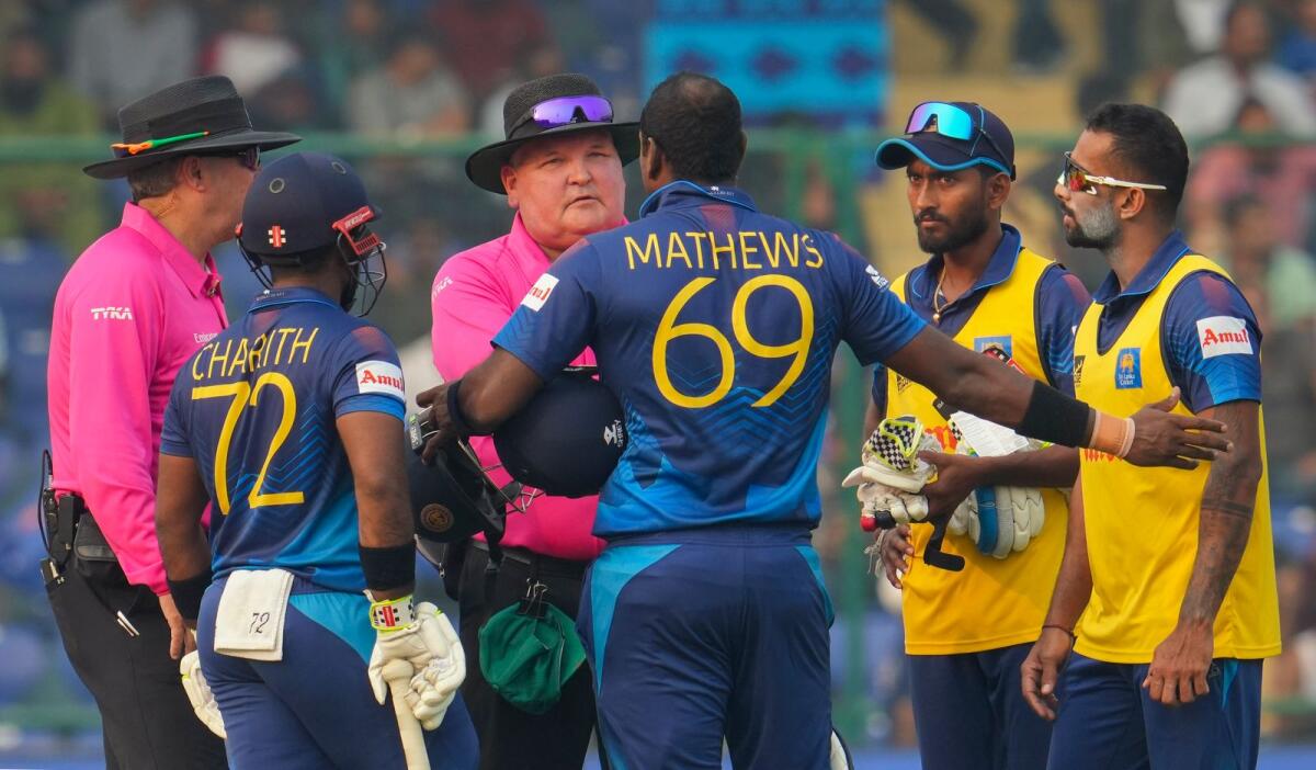 Sri Lankan batters Charith Asalanka and Angelo Mathews talk to umpires after the latter was  given 'timed out' during the match against Bangladesh. — PTI