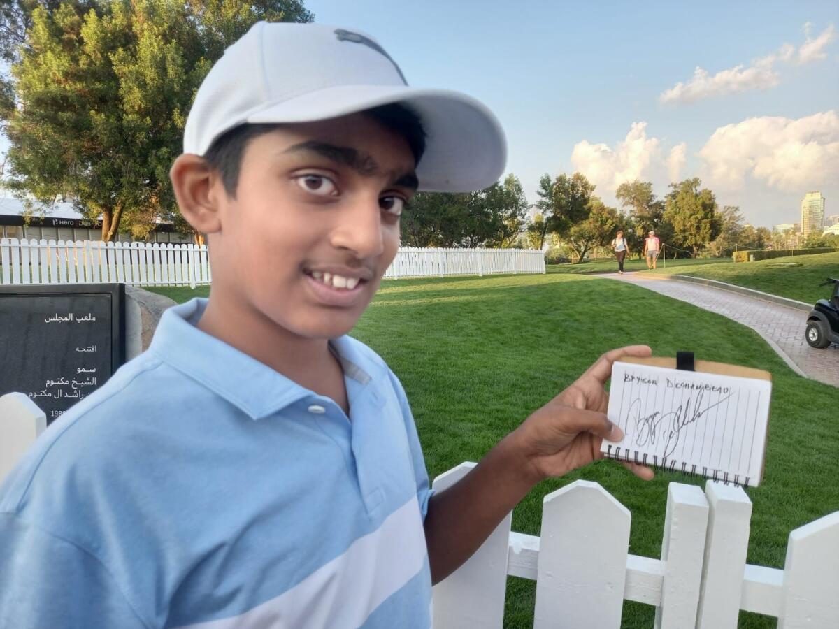 Ayaan Khan poses with his autograph book. — Photo by Leslie Wilson Jr