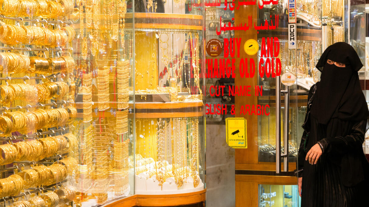 A shopper browses gold jewellery in Dubai. — File photo
