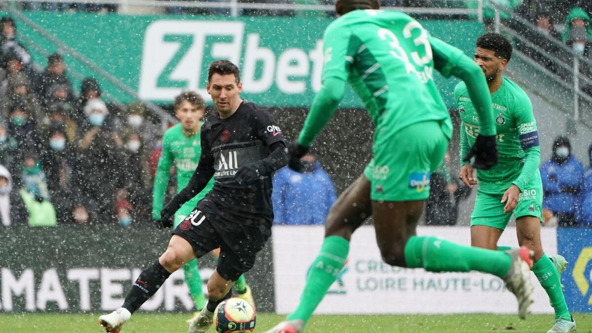 PSG's Lionel Messi (left) challenges for the ball with Saint-Etienne players during the Ligue 1 match on Sunday. (AP)