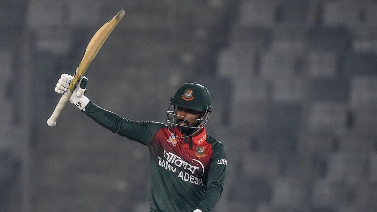 Bangladesh's Liton Das raises his bat as he celebrates his half century (AFP)