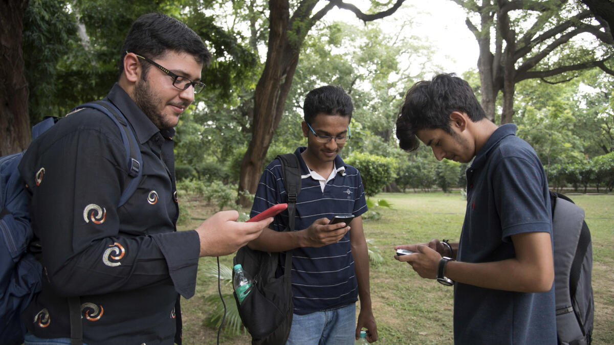 In this Monday, July 22, 2016 photo, Pokemon Go players meet in Lodhi Garden in New Delhi, India. 'Pokemon Go,' the highly addictive online game, has landed in India and thousands are out searching for pokemon characters as the mania spreads. Although it has not been launched officially in India, the augmented-reality-based game has caught on, with fans also using virtual private networks (VPNs) to change their locations and catch pokemons in New York and London while sitting in their Indian homes. (AP Photo/Thomas Cytrynowicz)