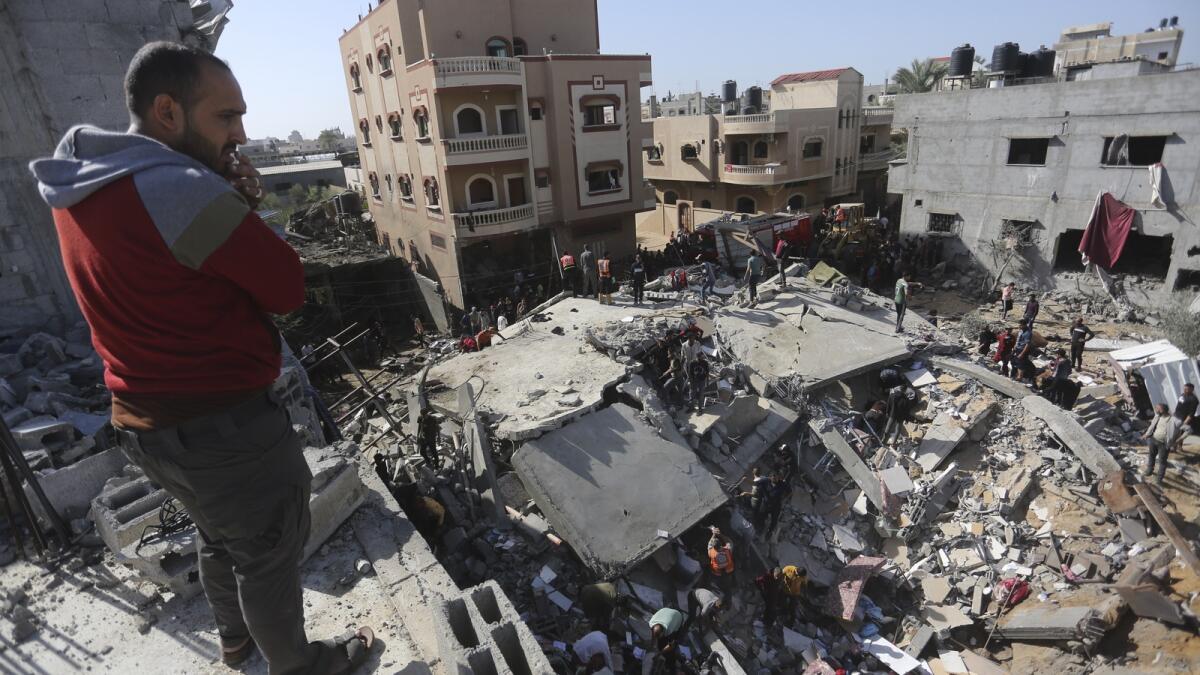 Palestinians look for survivors after an Israeli strike on the Gaza Strip in Rafah on Saturday, Nov. 23, 2023. AP