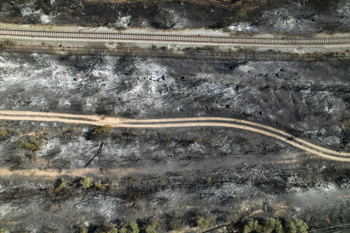 An aerial view of railway tracks in a burned area near the city of Volos on Thursday. — Reuters
