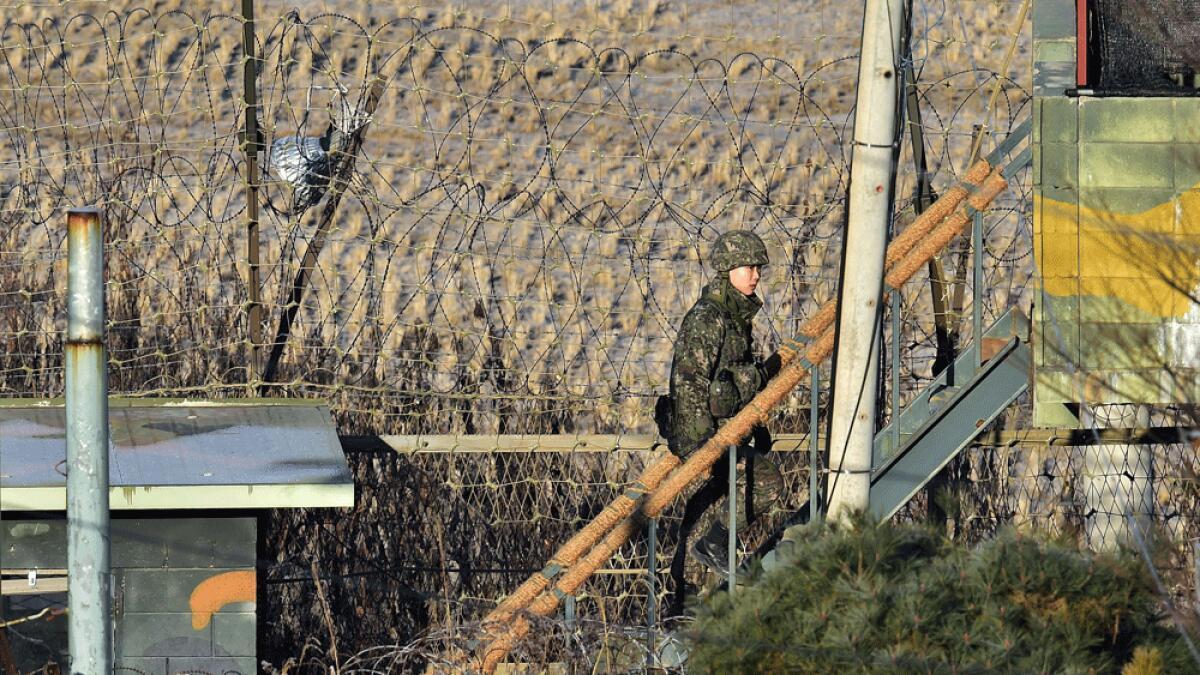A South Korean soldier walks up to a guard post at a military guard area in the border city of Paju near the Demilitarised zone dividing the two Koreas.