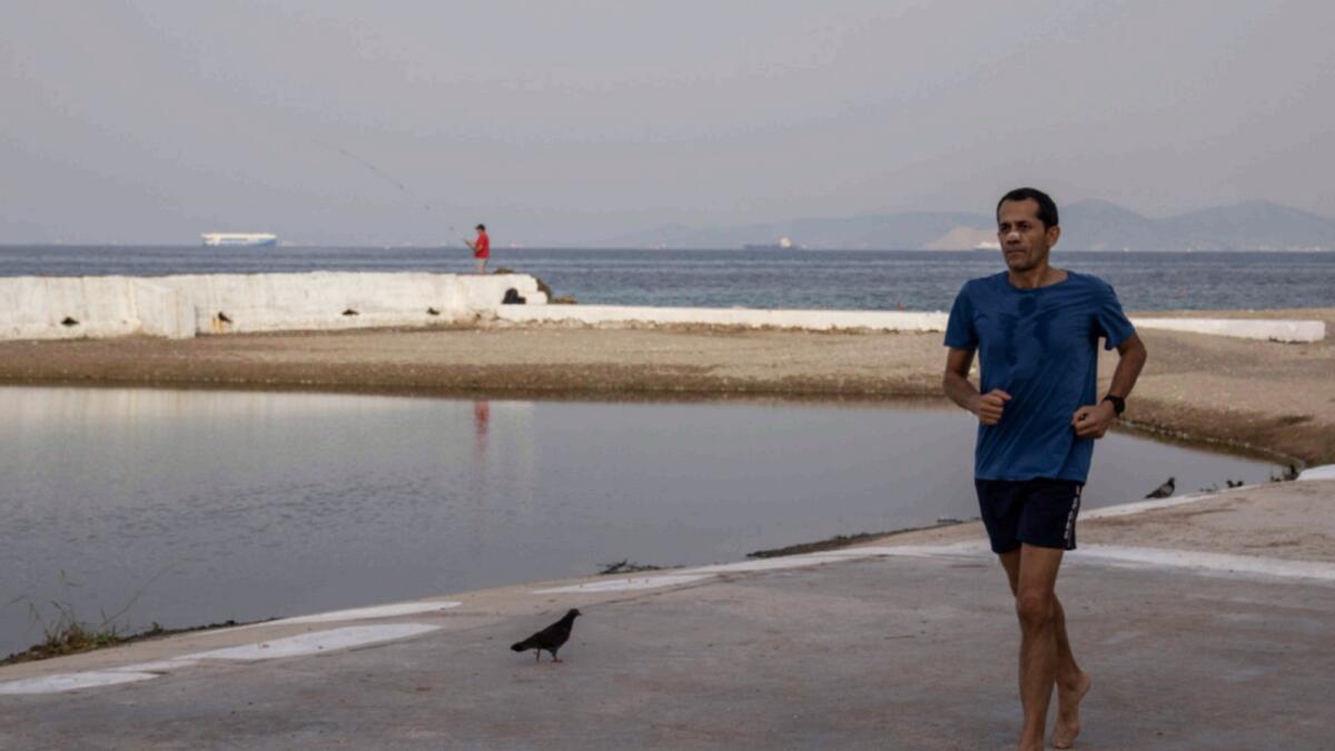 A man runs in the seaside suburb of the Alimos district of Athens. — AP