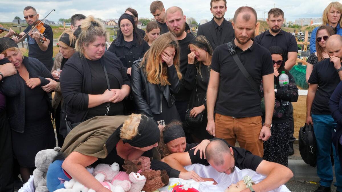 Relatives and friends attend the funeral ceremony for Liza, 4-year-old girl in Vinnytsia, Ukraine, on Sunday.