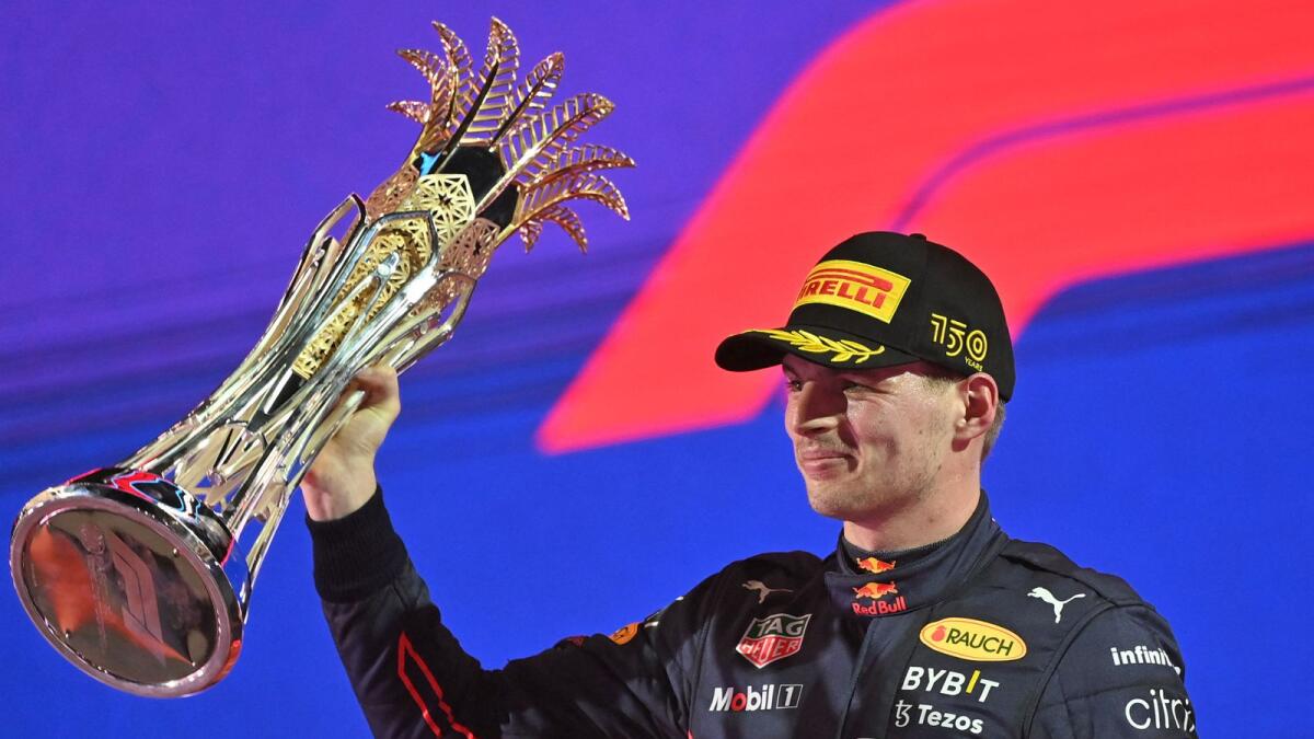 Max Verstappen raises the trophy on the podium. (AFP)