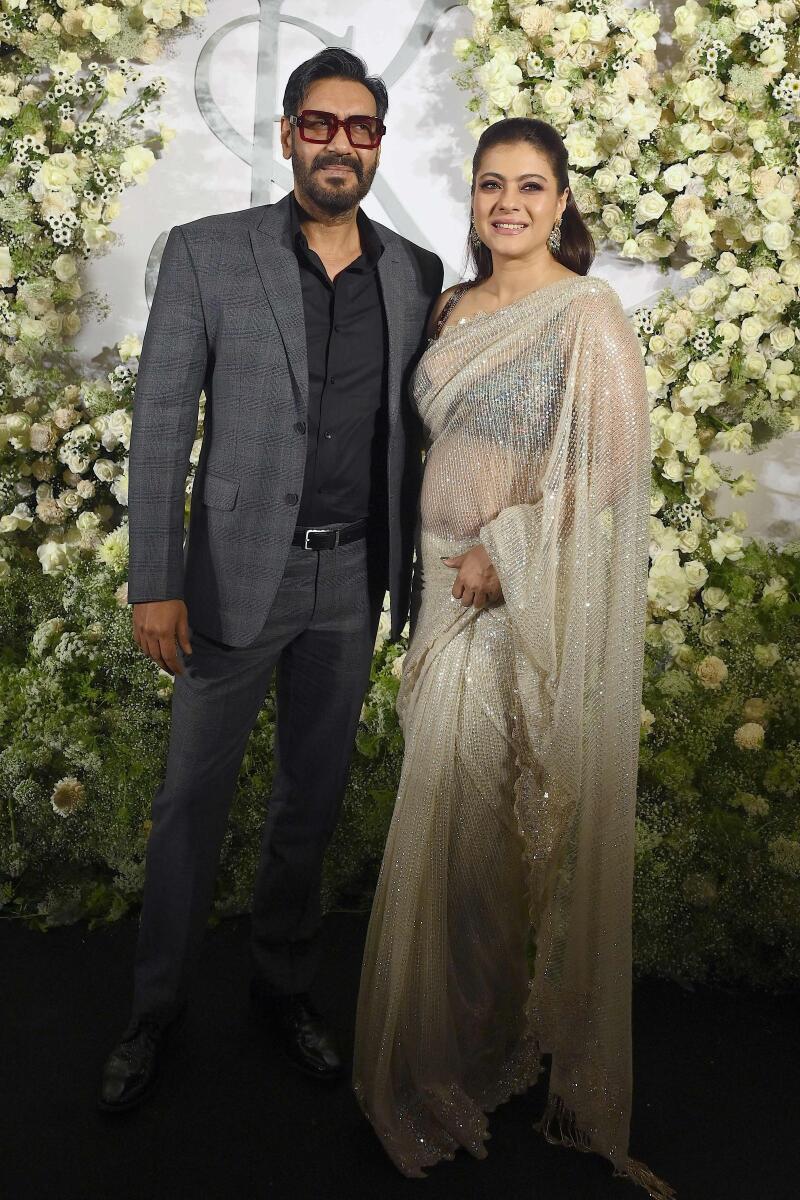 Ajay Devgn and wife Kajol made for the perfectly matched couple; him in a sharp suit and her in a transparent sari that shone and sparkled in the light