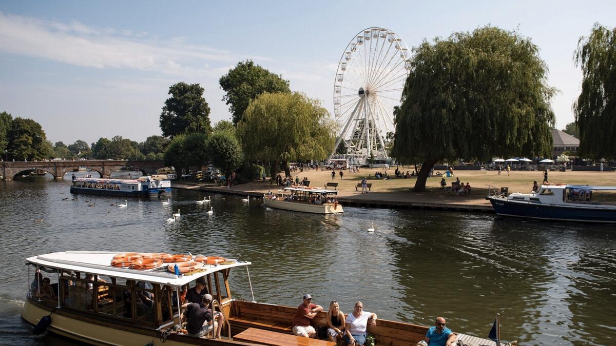 People enjoy the hot weather in Stratford-upon-Avon, England. After days of scorching temperatures, large swathes of the UK could be hit by severe thunderstorms this week. Photo: AP