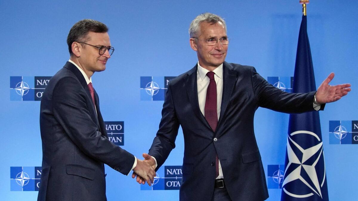 Ukrainian Minister for Foreign Affairs Dmytro Kuleba (L) shakes hands with Nato Secretary General Jens Stoltenberg (R)  in Brussels on Wednesday. — AFP