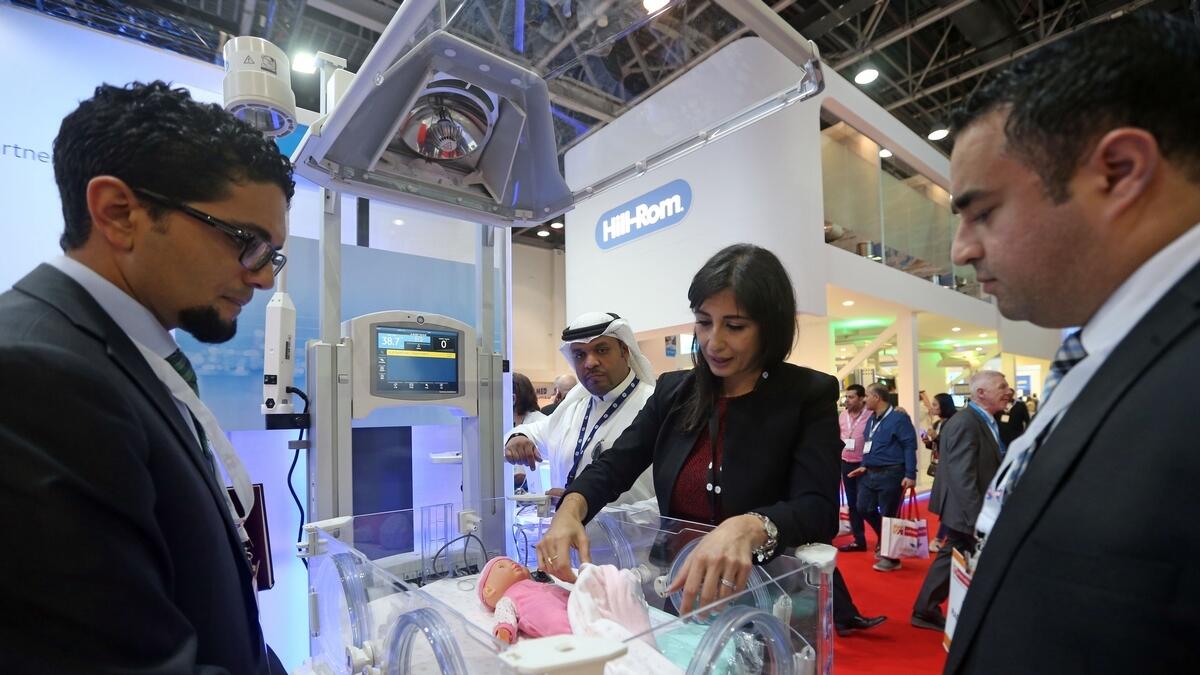 Visitors check an incubator on display at the GE stand.  Photo by Dhes Handumon