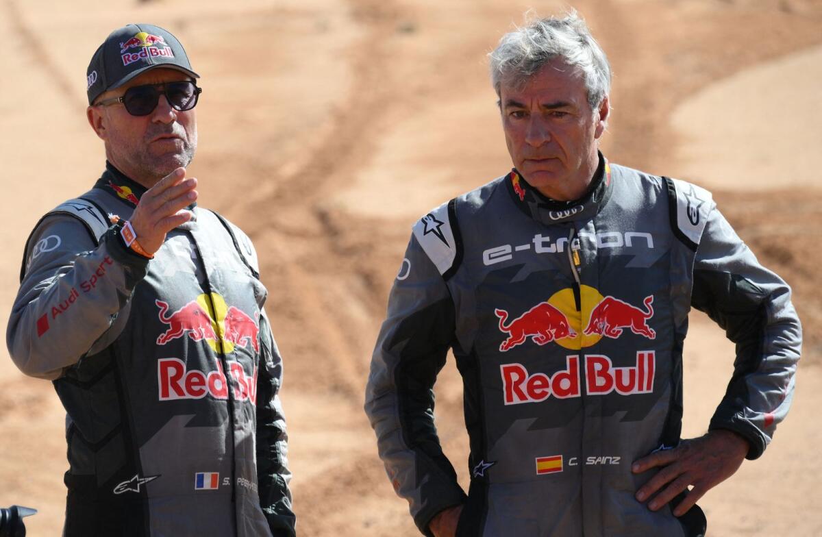 Stephane Peterhansel of France (left) and Carlos Sainz of Spain react after a crash. —  AFP