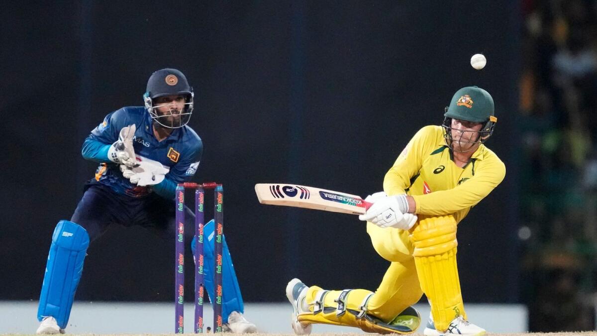 Australia's Alex Carey plays a shot as Kusal Mendis watches during the fifth ODI in Colombo on Friday. — AP