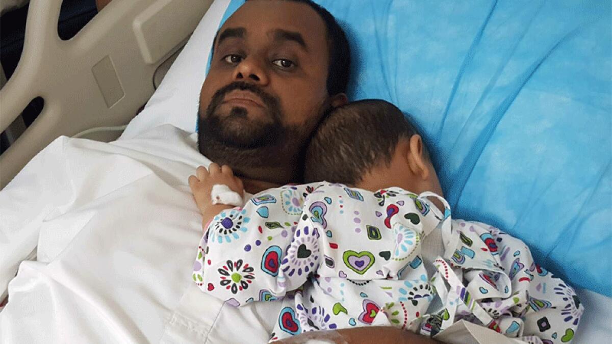 Mohammed Salim with another son of his at Al Qasimi Hospital, Sharjah, on Monday.