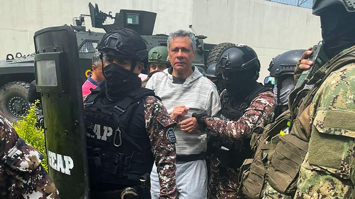 Former Ecuadorian vice president Jorge Glas being escorted by members of the Special Penitentiary Action Group (GEAP) during his arrival at the maximum security prison La Roca in Guayaquil on Saturday. — AFP