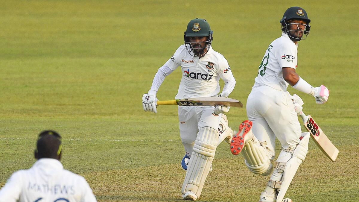 Bangladesh's Najmul Hossain Shanto (right) and teammate Mominul Haque take a run during the first day of the first Test against Sri Lanka. — AFP