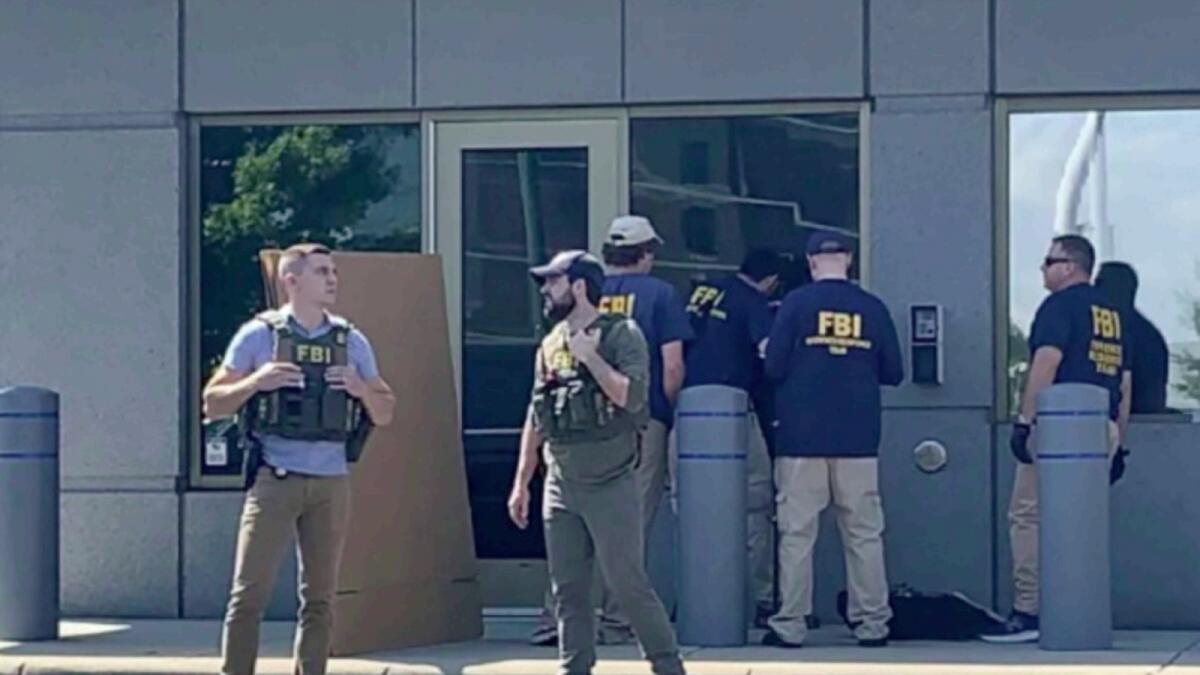 FBI officials gather outside the FBI building in Cincinnati. — AP