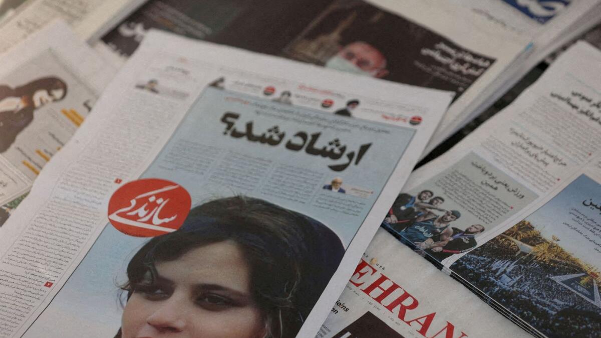 A newspaper with a cover picture of Mahsa Amini, a woman who died after being arrested by Iranian morality police, is seen in Tehran on September 18, 2022. — Reuters file