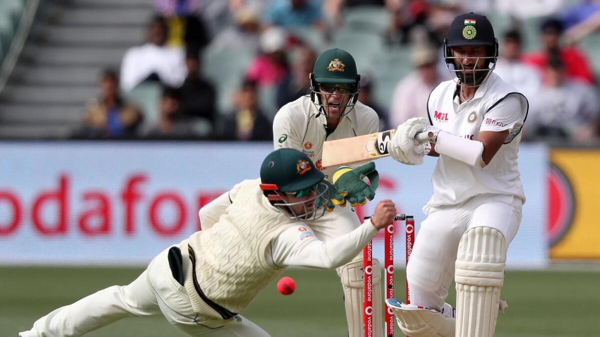 Australia's Travis Head dives in attempt to catch out India's Cheteshwar Pujara. — AP)