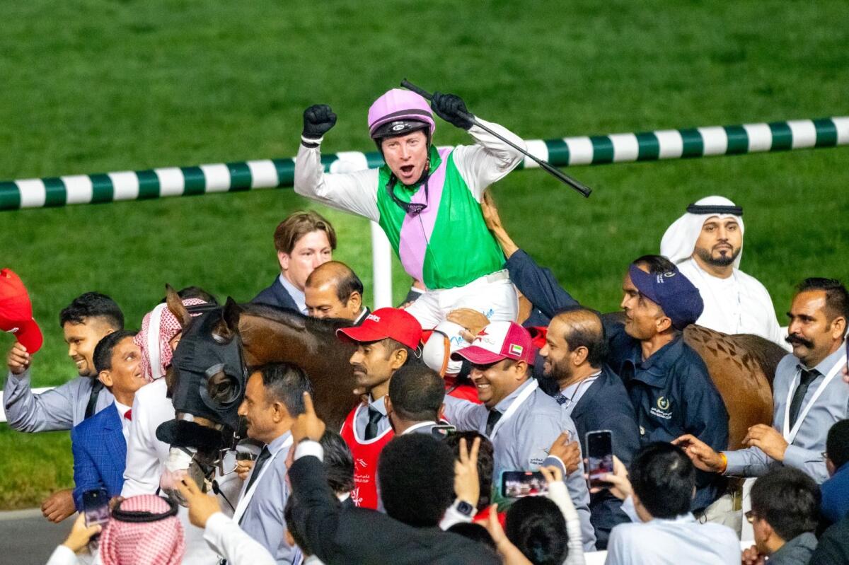 Jockey Tadhg O’Shea celebrates the Dubai World Cup win on Laurel River. — Photo by Shihab