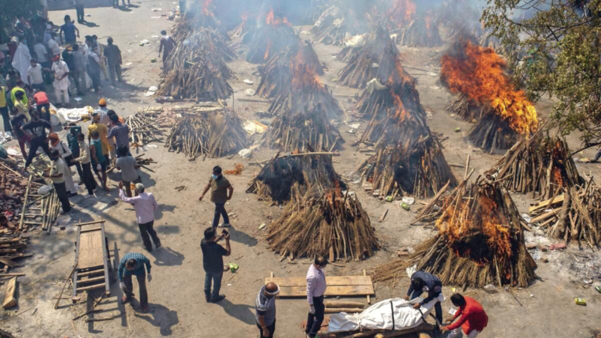 Multiple funeral pyres of victims of Covid-19 burn at a ground that has been converted into a crematorium for mass cremation in New Delhi in April during the second wave. — AP file