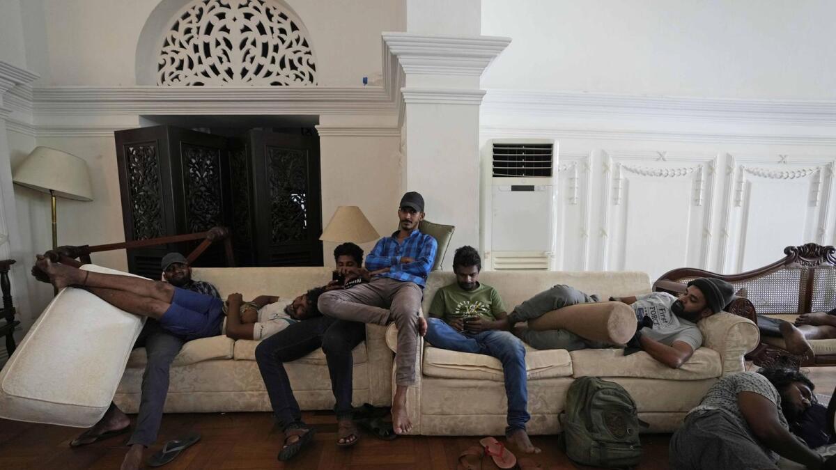 Protesters rest on sofas in the living hall of Prime Minister's official residence