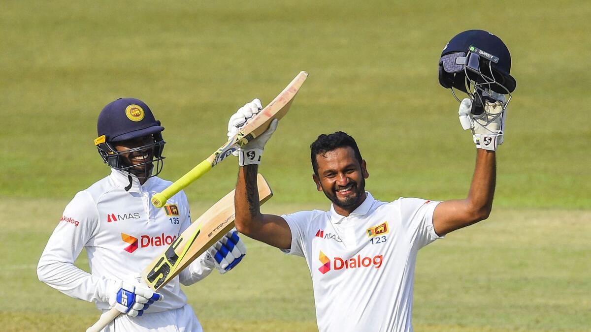 Sri Lanka's Dimuth Karunaratne (right) celebrates after scoring a double century (200 runs) as teammate Dhananjaya de Silva looks on. — AFP