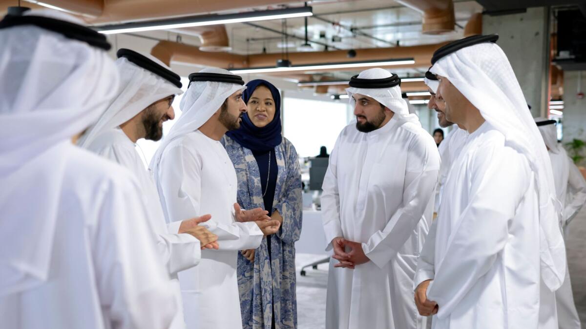 Sheikh Hamdan interacts with officials during his visit to the Department of Economy and Tourism on Monday.