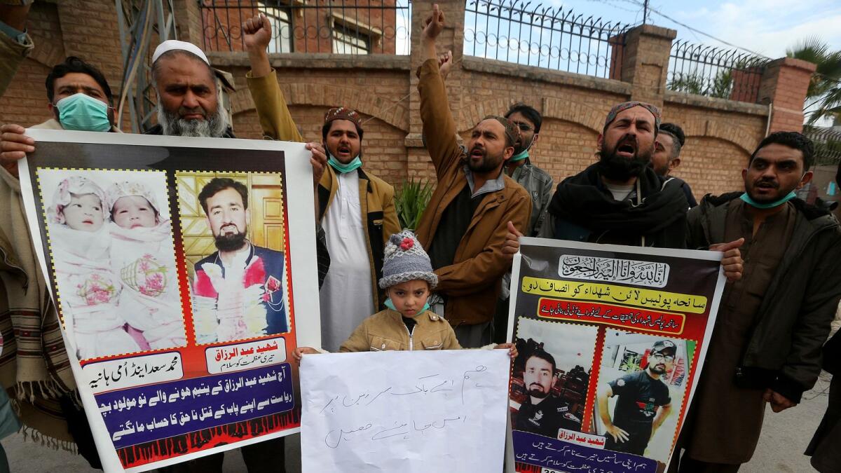 Family members of police officers, who were killed in Monday's suicide bombing, take part in a rally denouncing militant attacks and demanding peace in the country, in Peshawar, Pakistan, on Friday. — AP