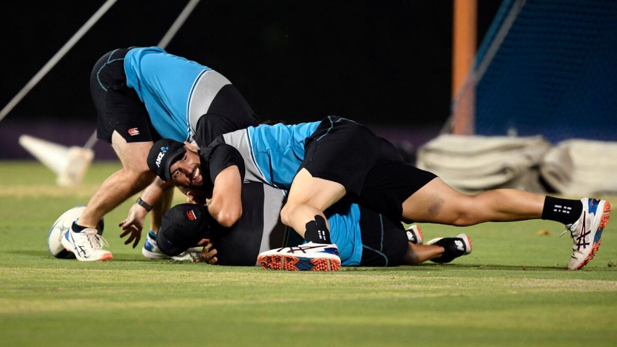 New Zealand players shares a light moment during a practice session in Dubai on Saturday. — AFP